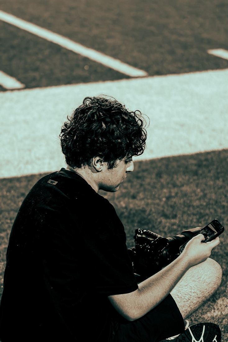Hassan Naji on the field reviewing shots on his camera